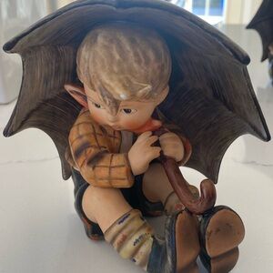 Boy looking down German Hummel. Great condition.